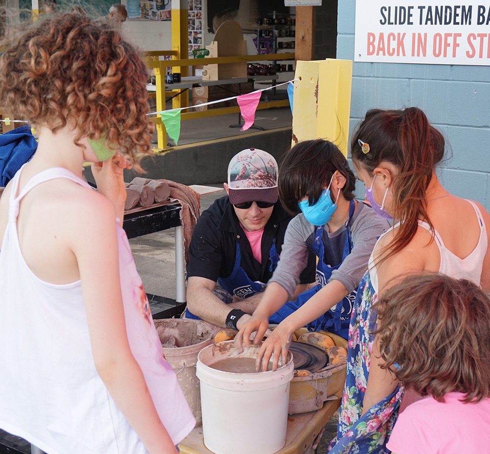 Corey teaching some pottery at the block party